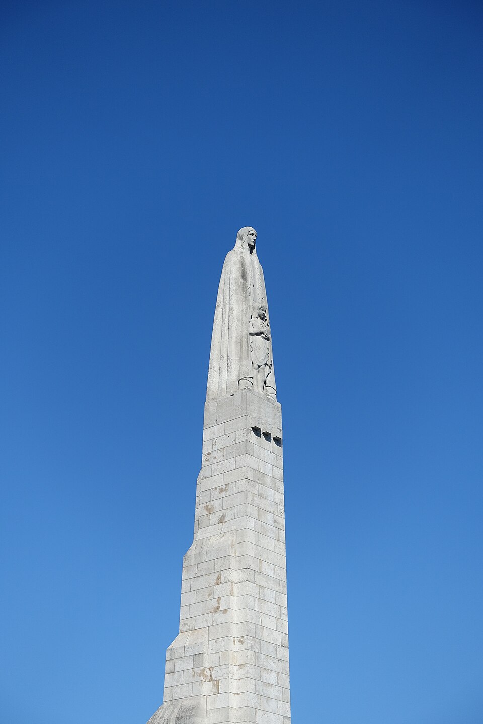 A statue of Saint Genoveve on a bridge in Paris, France